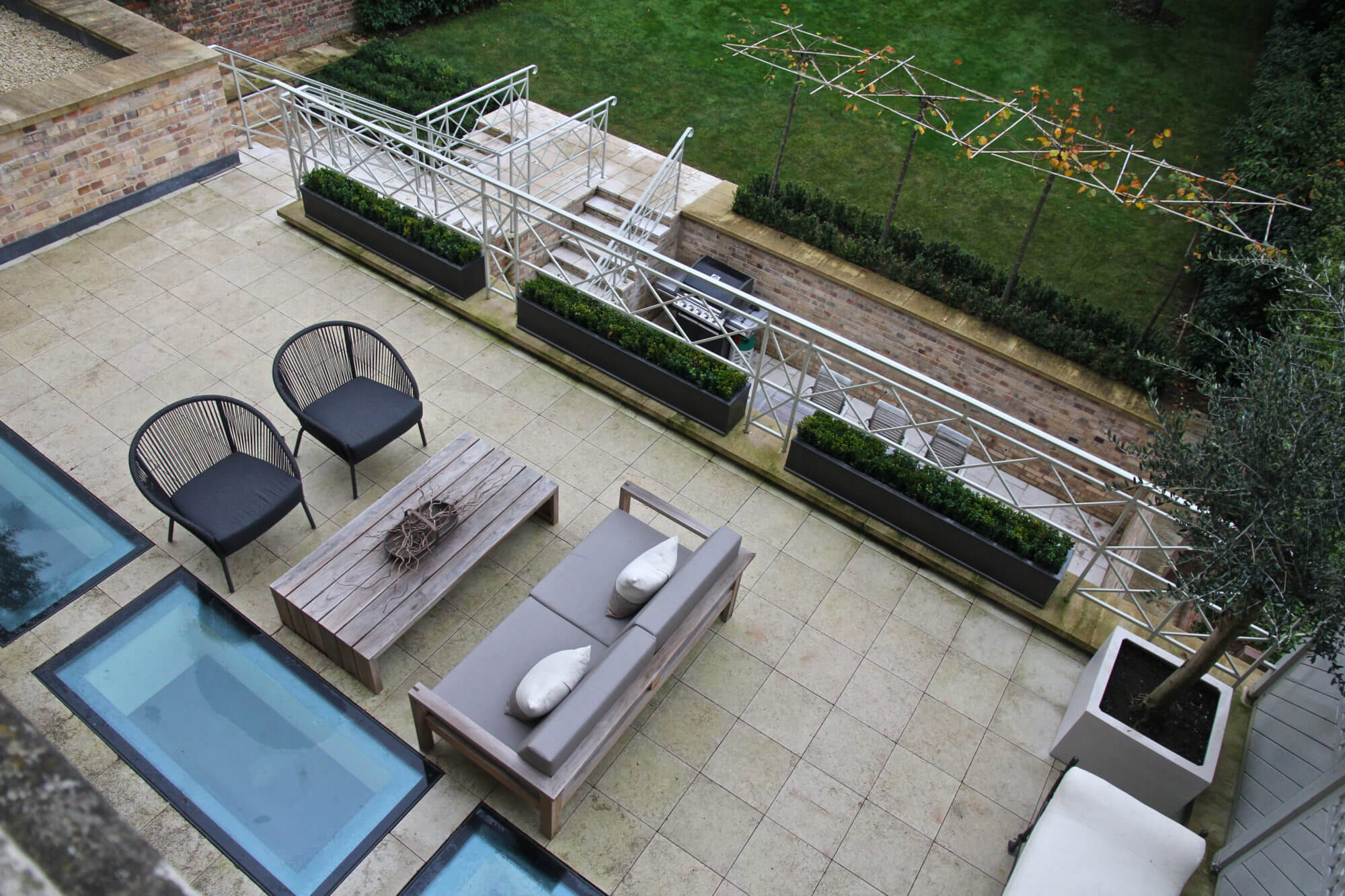 Ariel shot of roof terrace, with outdoor furniture, elements of water and topiary