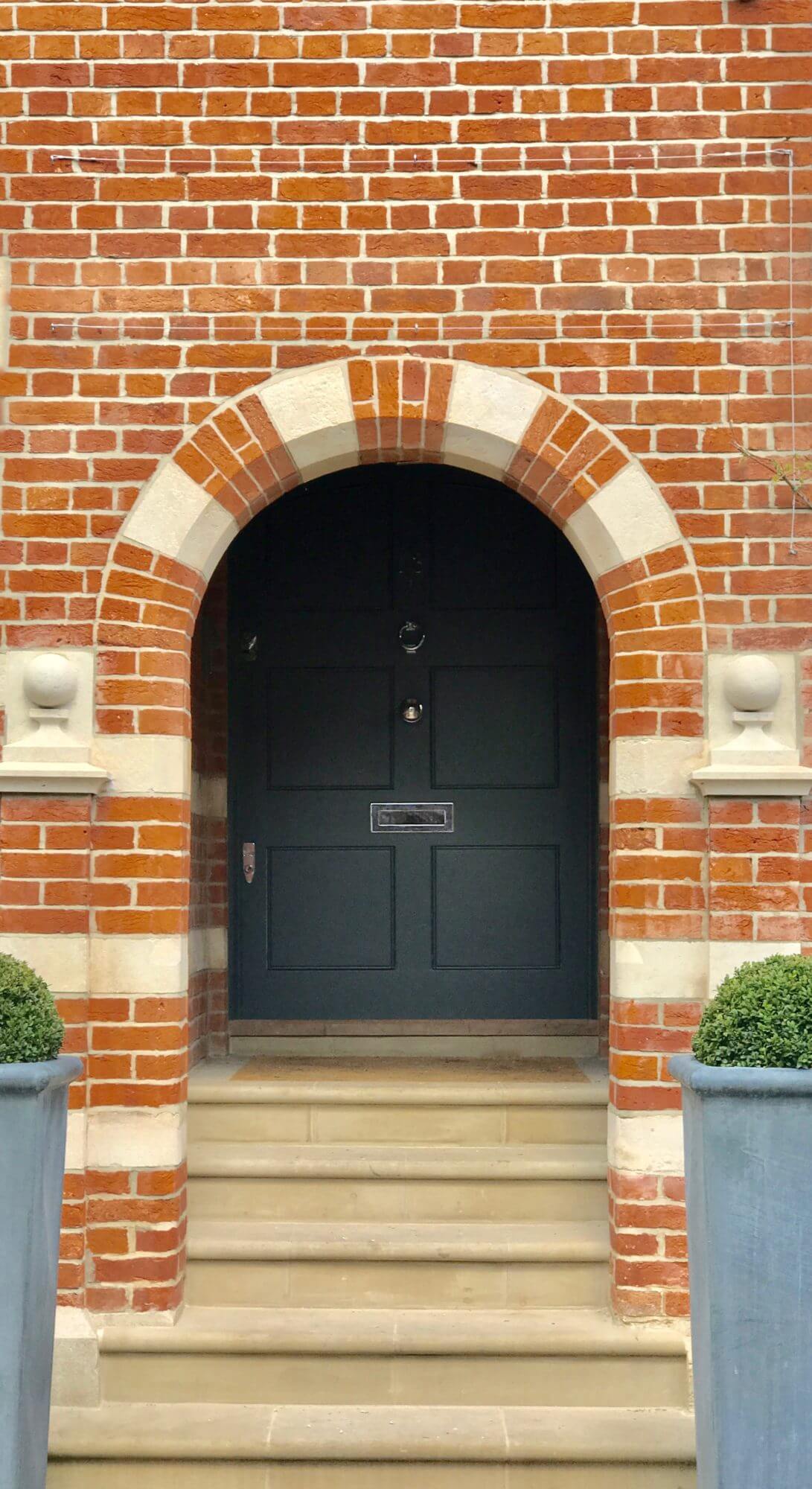 Oxford Victorian townhouse brick Homefront with bullnose steps and an archway door painted in Farrow & Ball Downpipe