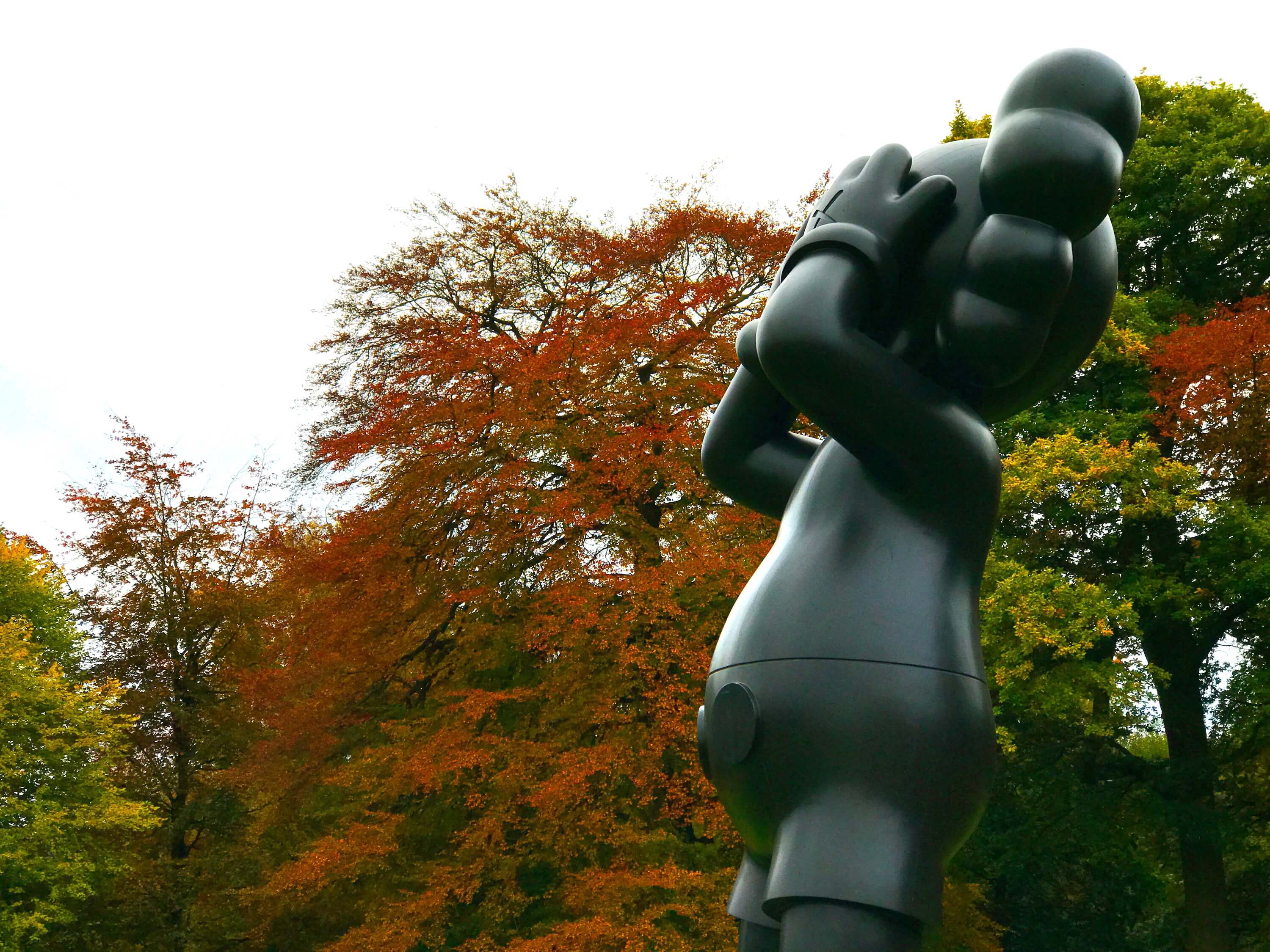 Kaws landscape art sculpture at a sculpture park in Autumn