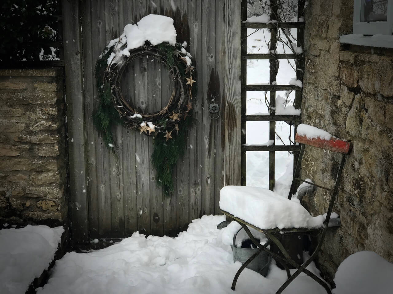 rustic cottage at Christmas covered in snow