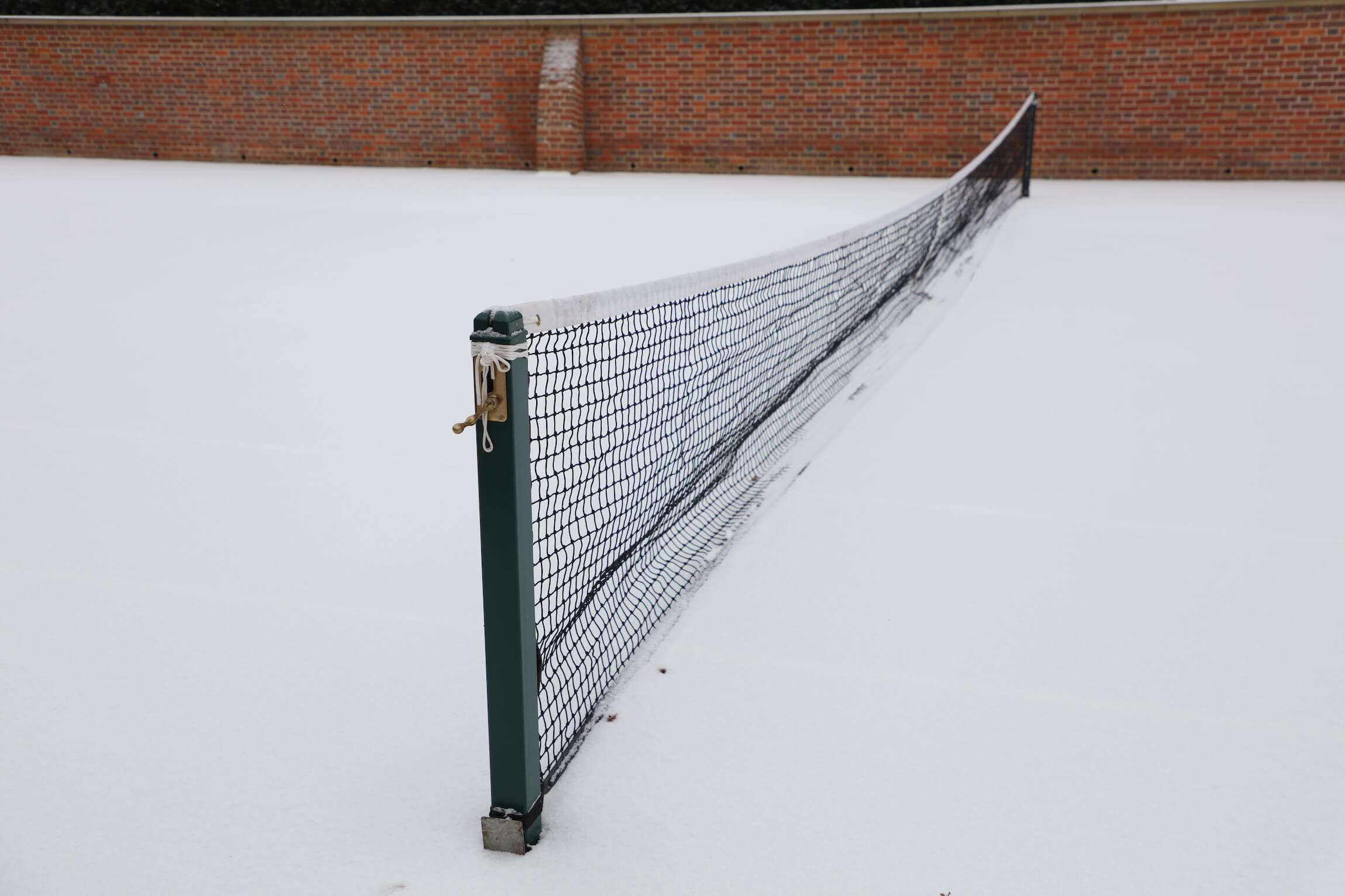 tennis court covered in snow