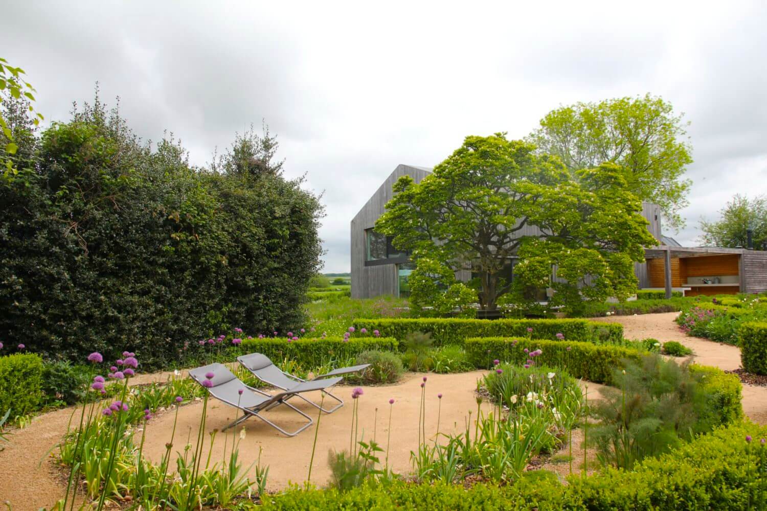 modern country living landscape of topiary hedges in a swirl