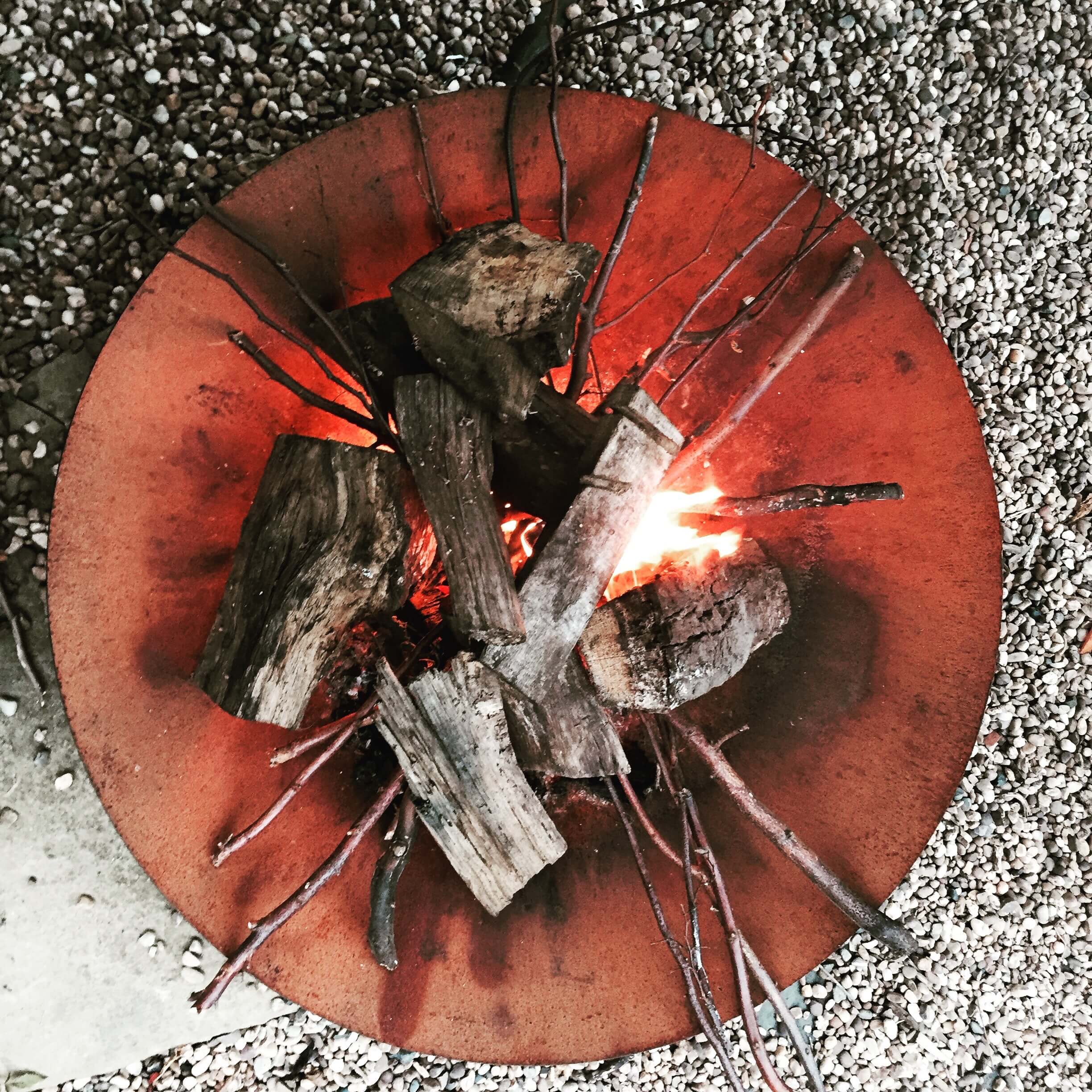 glowing fire bowl in autumn garden