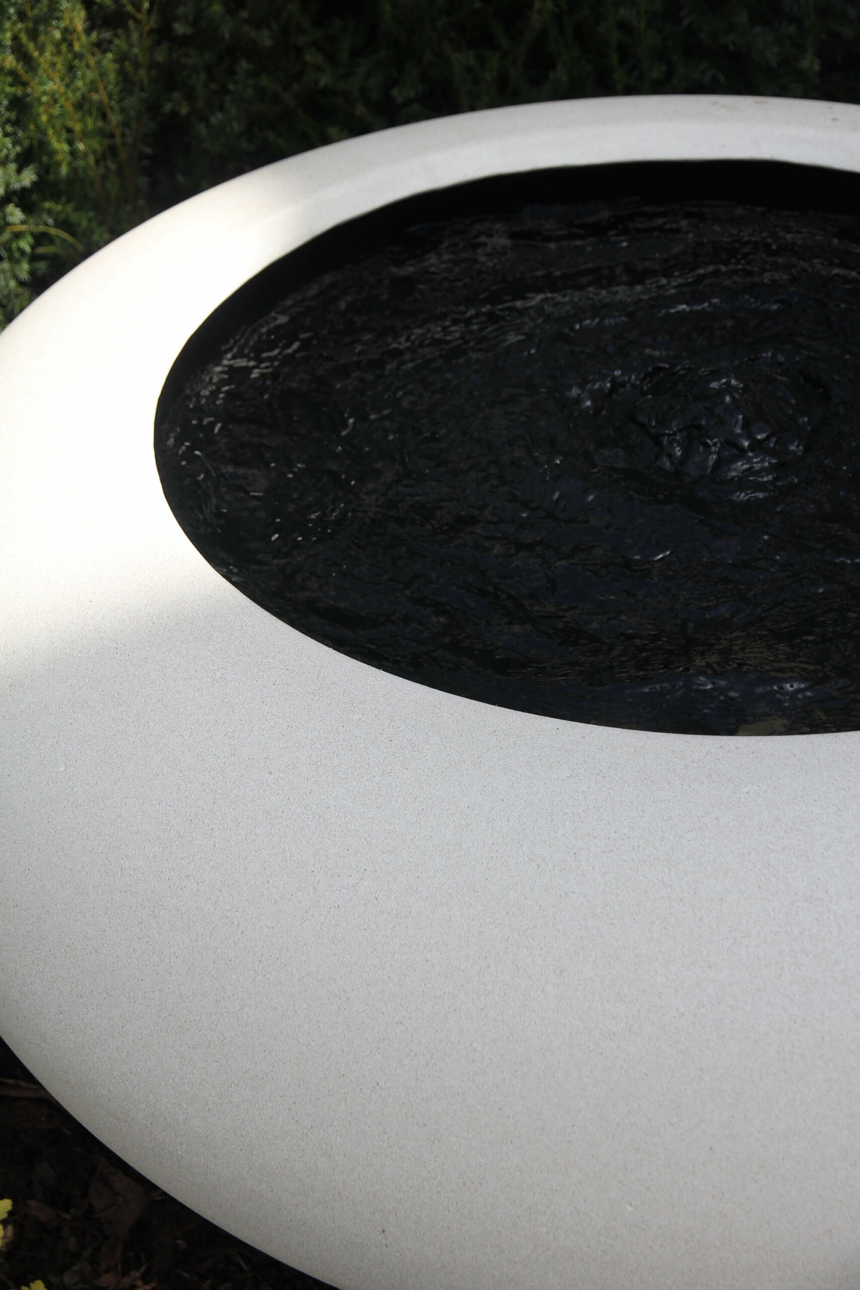 white garden water feature bowl and black water