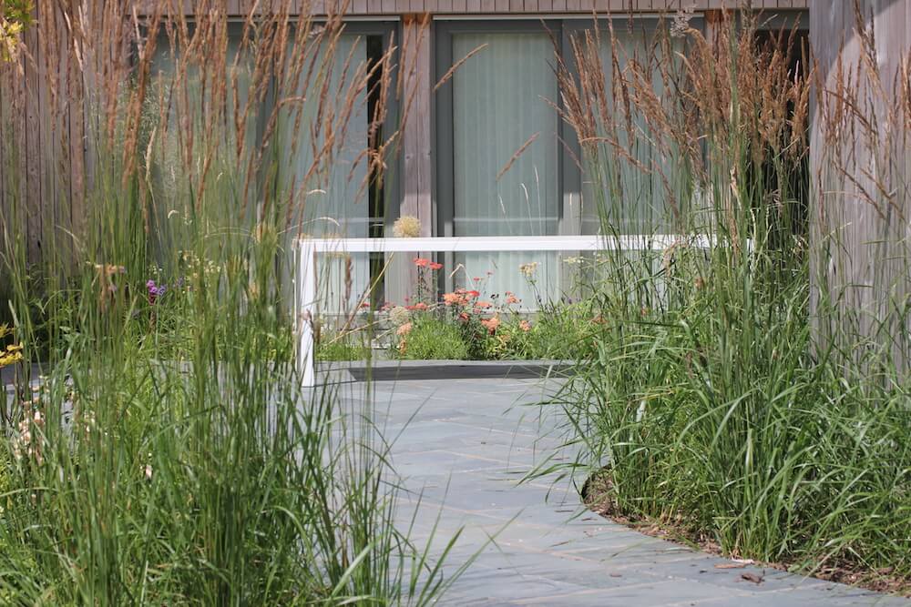 wildflower garden surrounding slate patio with white table