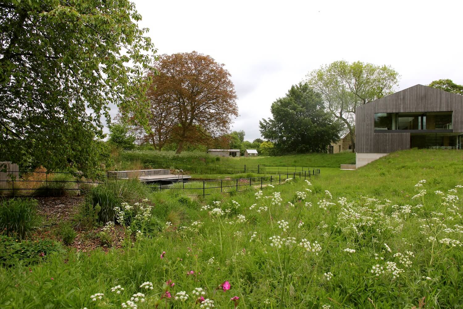 Far End meadows prairie landscape with natural swimming pool summertime