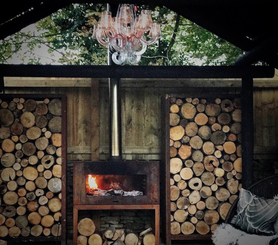 autumn in the shack with log stores and outdoor chandelier
