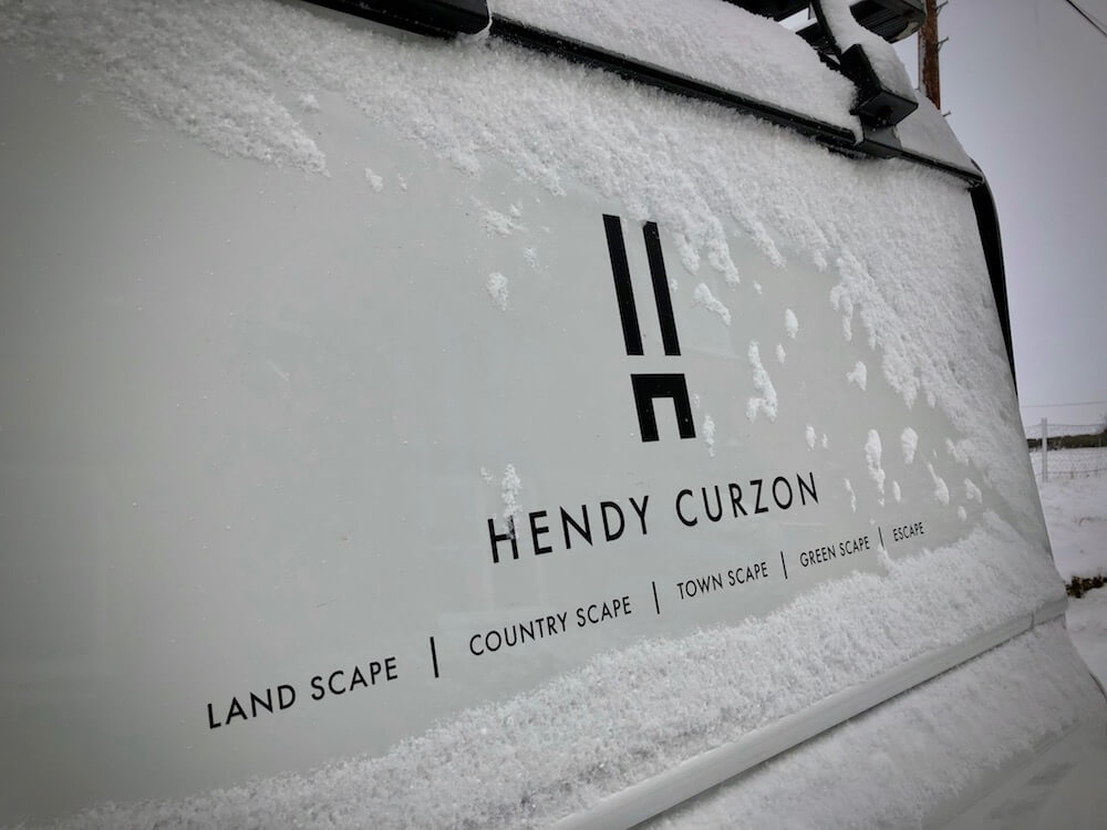 a landrover in a snowy cotswold landscape