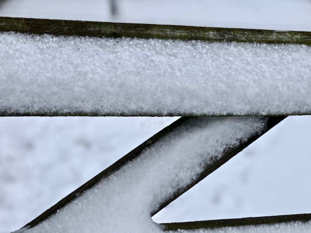 close up landscape fence in a snow covered cotswolds field