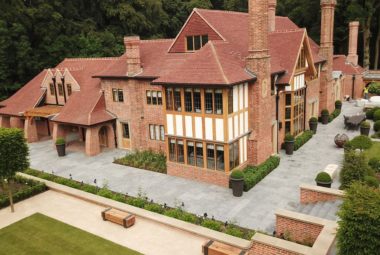 arts & crafts house in brick ariel shot with landscaped gardens