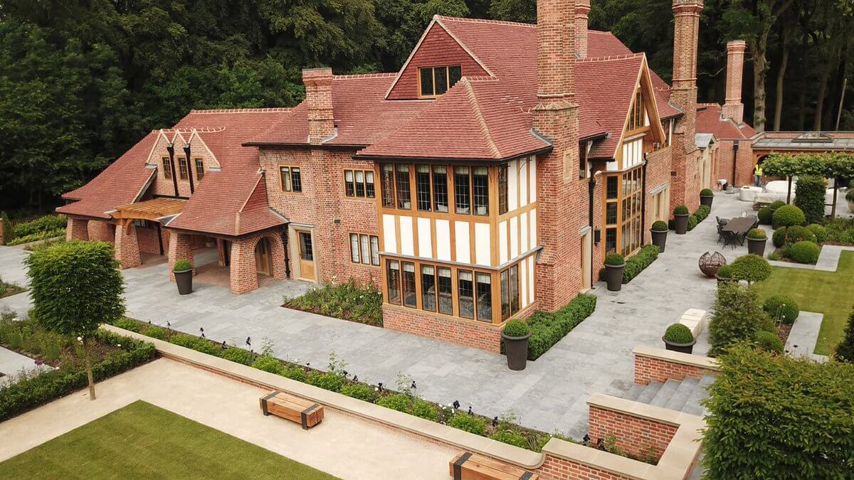 arts & crafts house in brick ariel shot with landscaped gardens