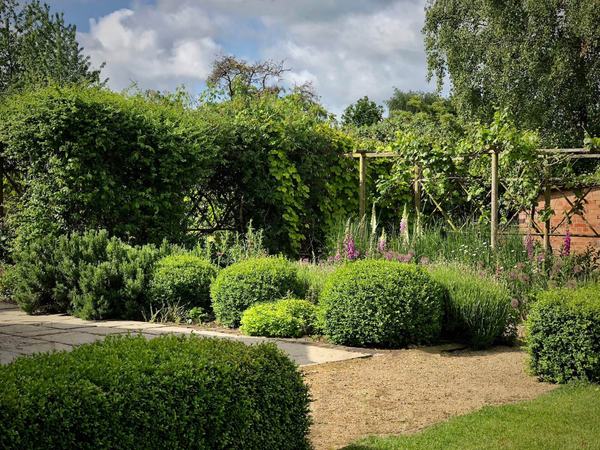 box topiary and cut flowers in a country garden