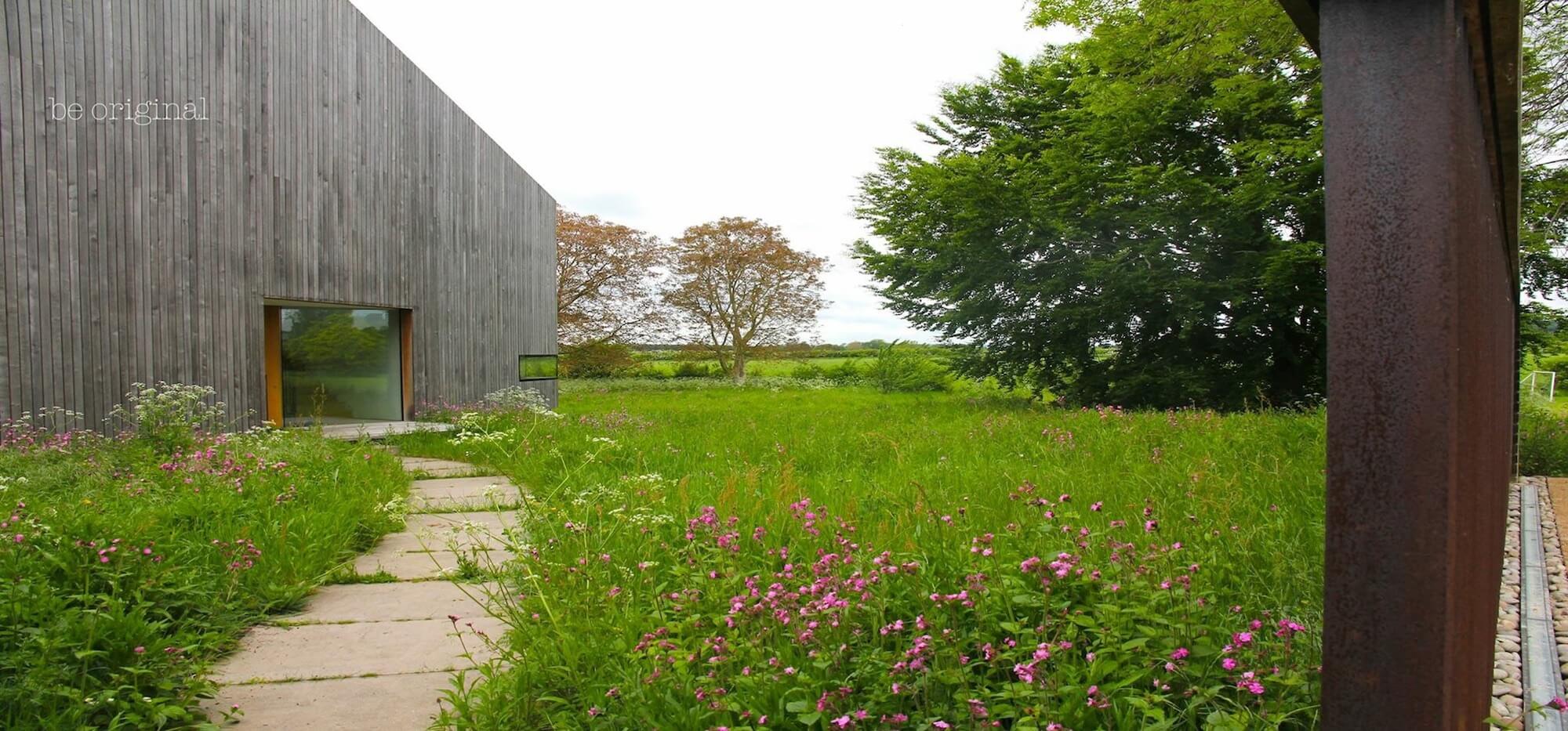 a modern barn house surrounded by wildflower meadows in Kingham