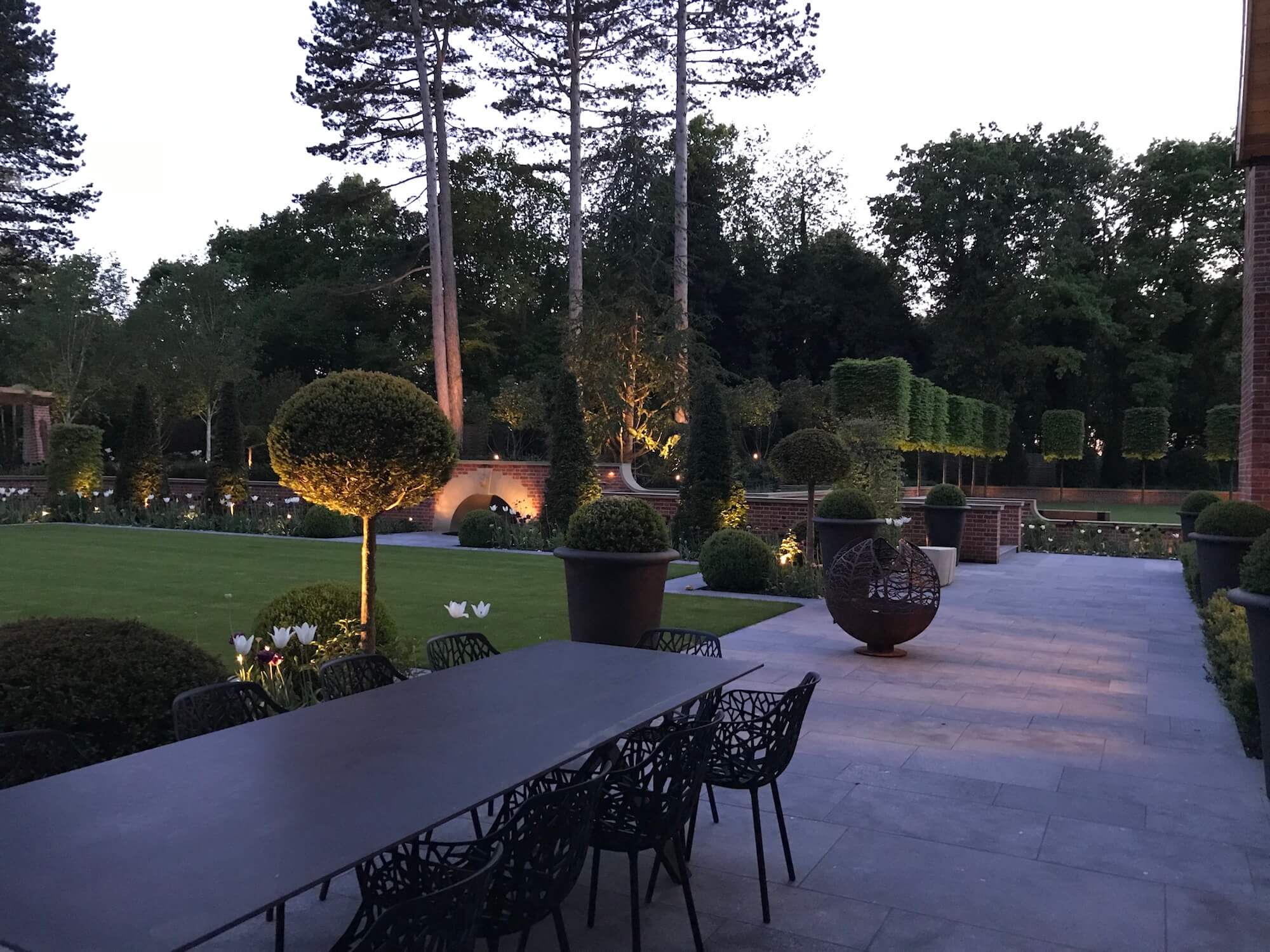 an estate garden with evening lighting