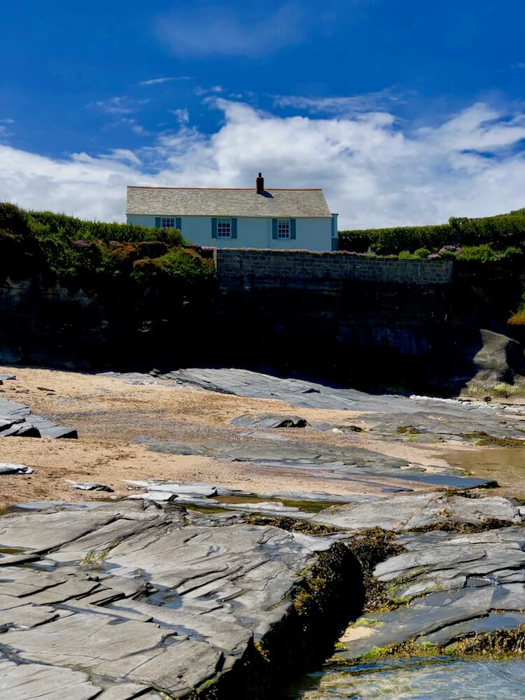 a Cornwall house on a cliff looking over Constantine bay the house is white