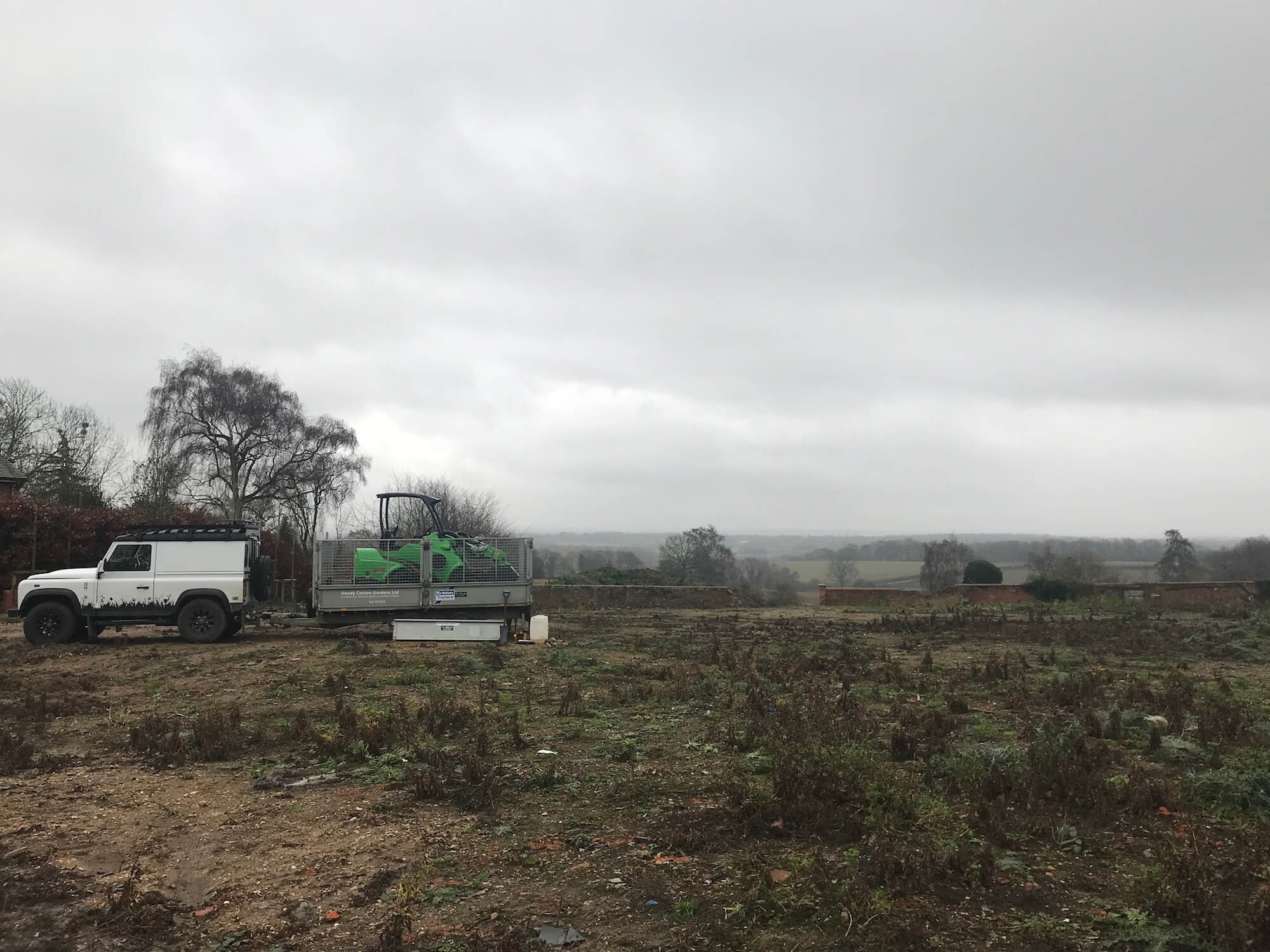 a wide landscape in henley-on-thames about to be landscaped with a Land Rover defender and avant on a trailer