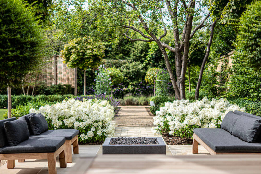 modern garden with white hydrangeas and Piet boon furniture