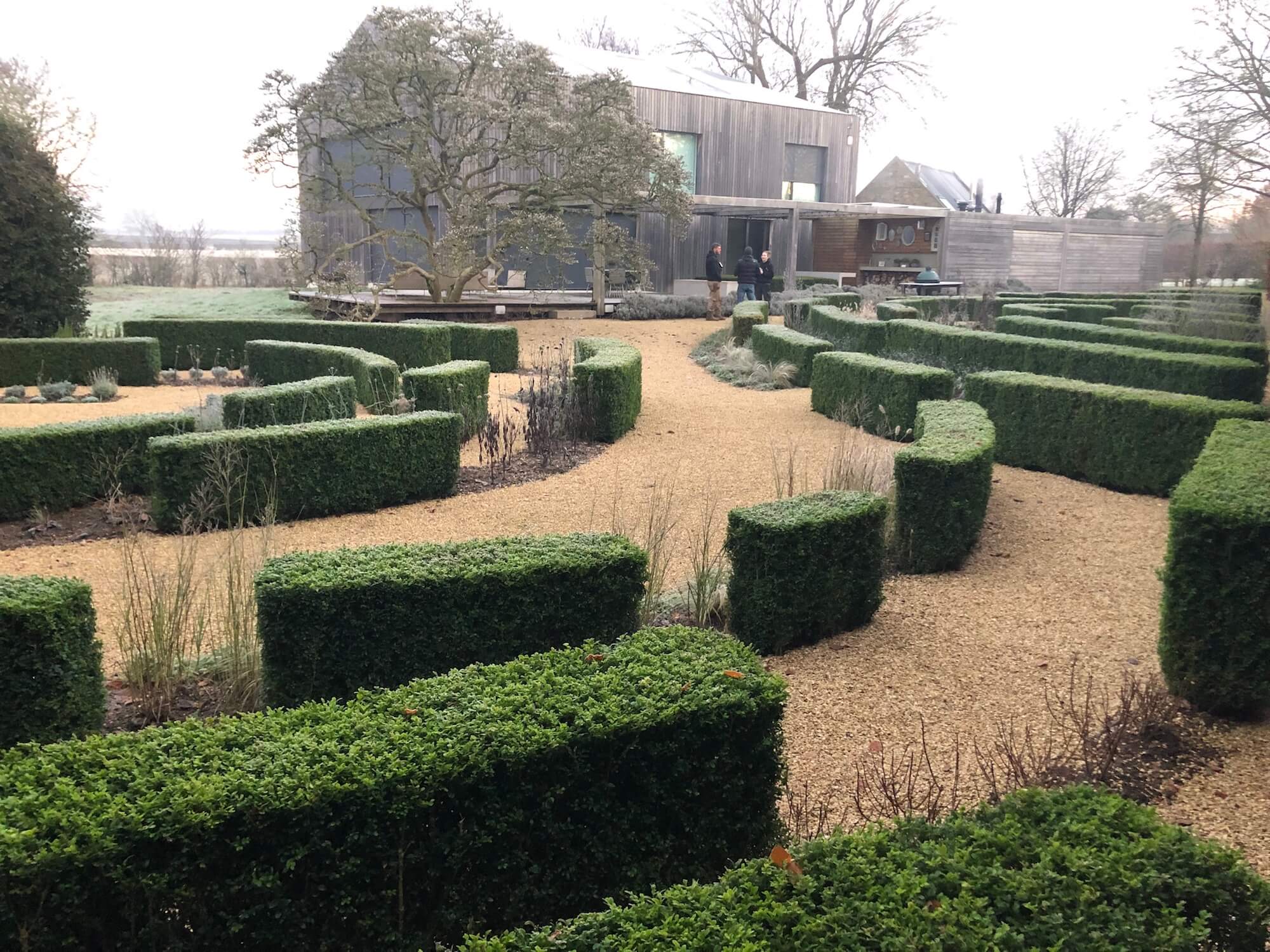 topiary parterre garden in winter landscape barn garden