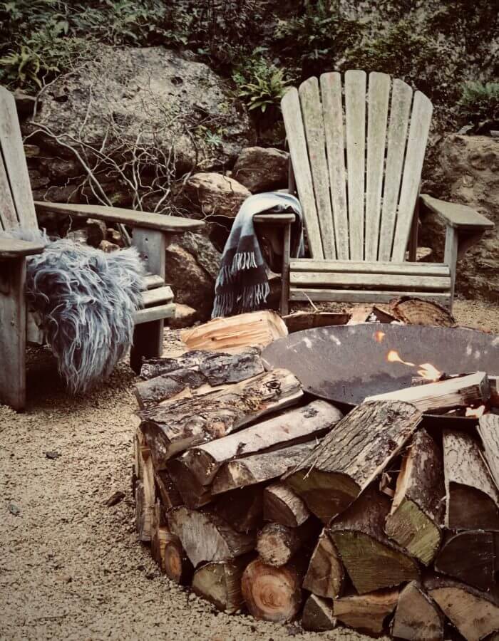 winter hygge garden with fire pit and Adirondack chairs