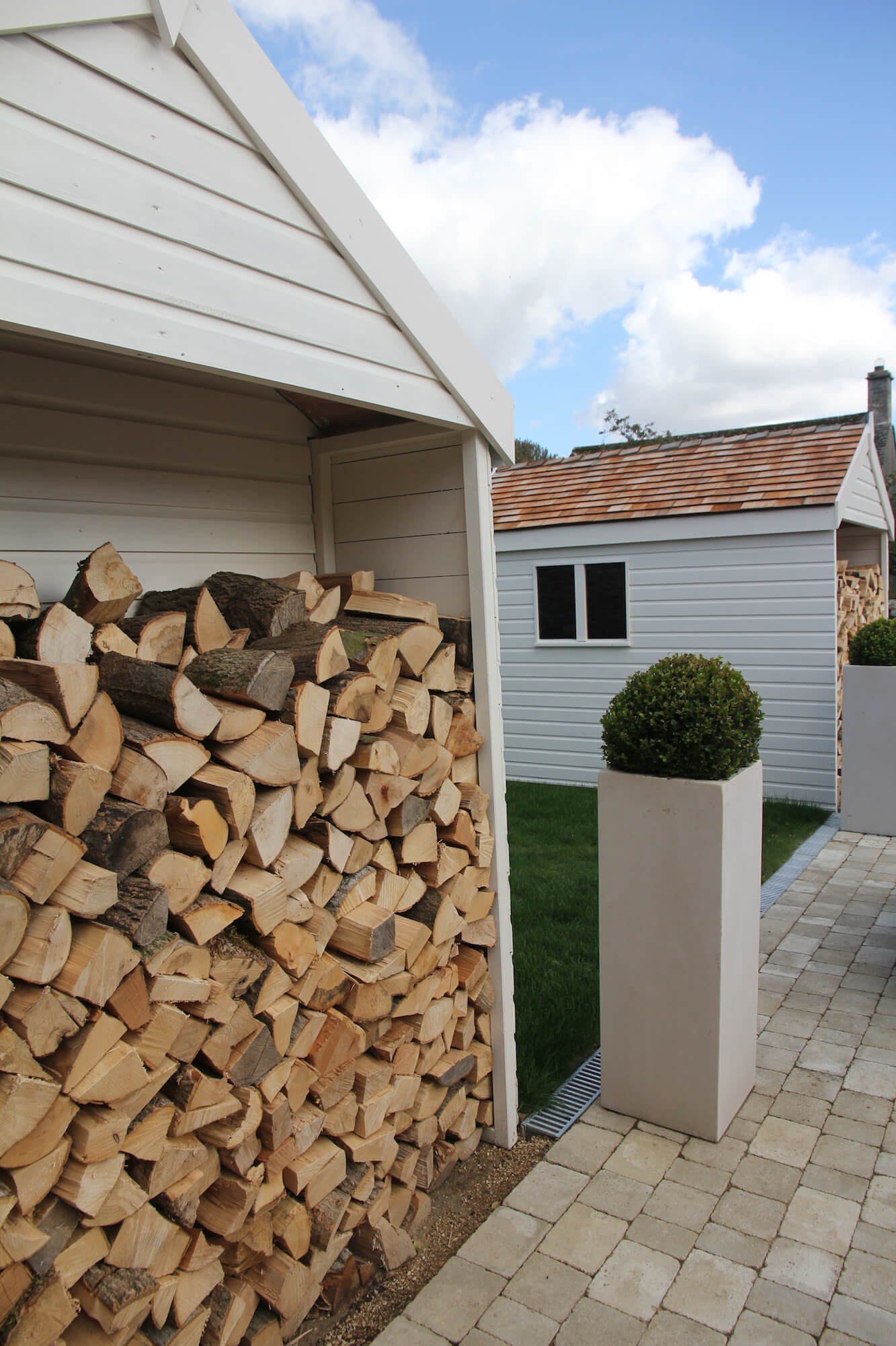 bespoke log and shed stores in a Burford garden