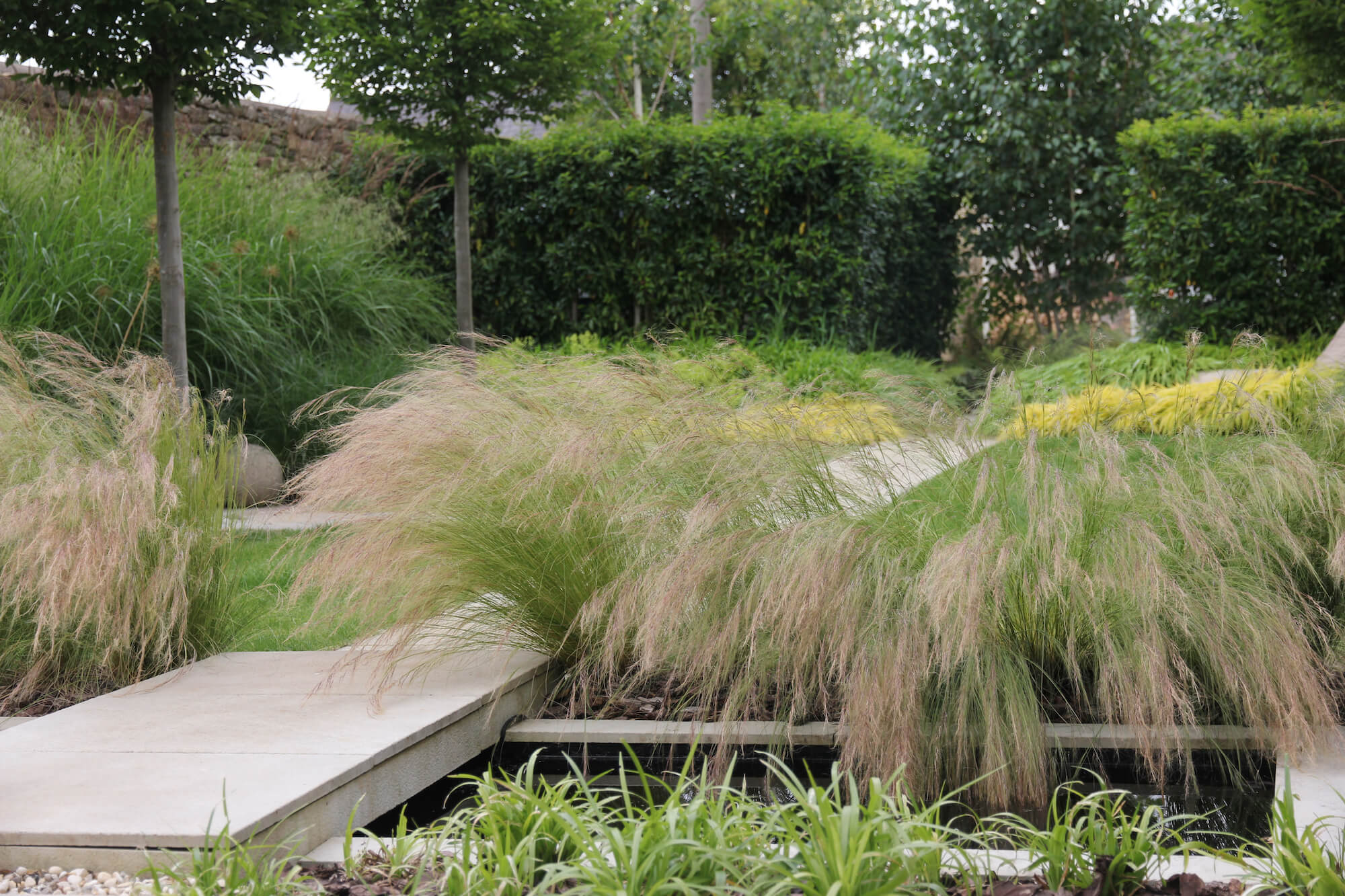 Burford garden with layered planting and water feature