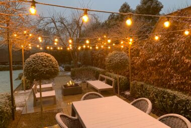 december garden with festoon lighting