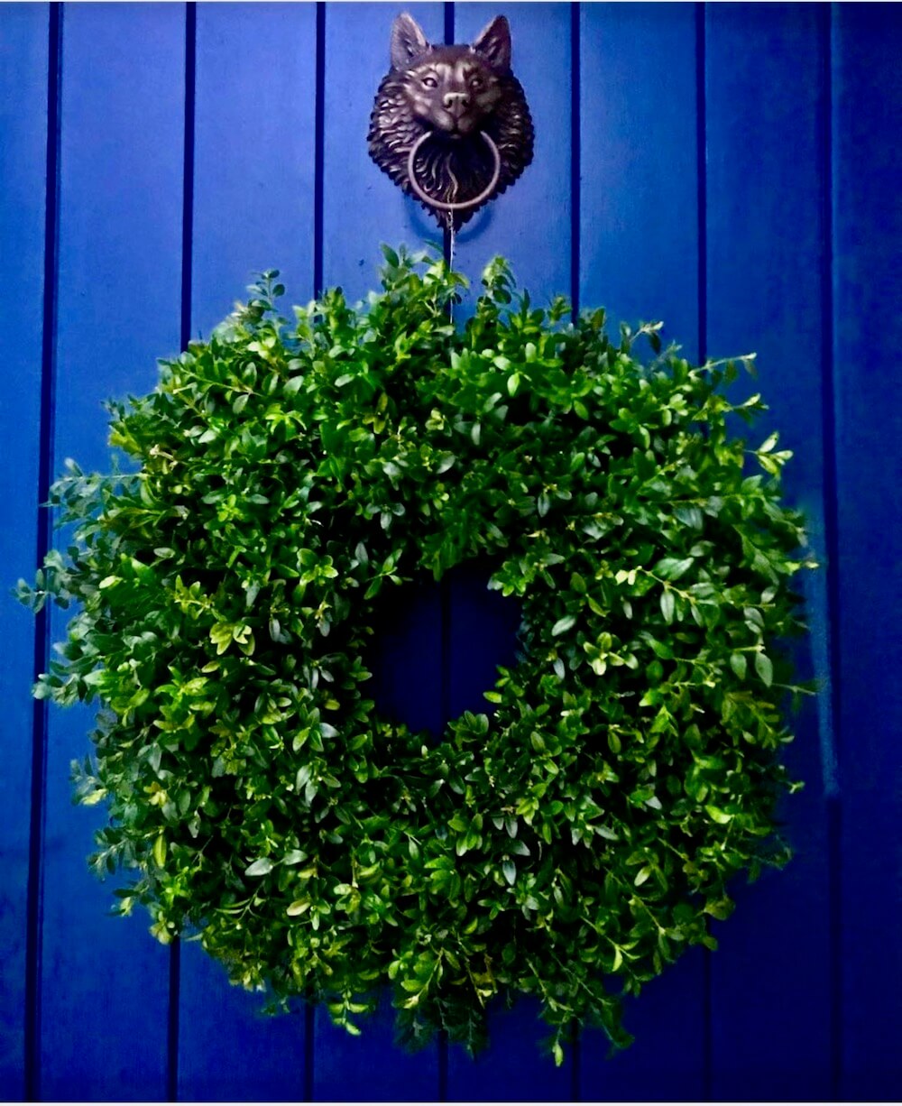 Buxus wreath against blue front door