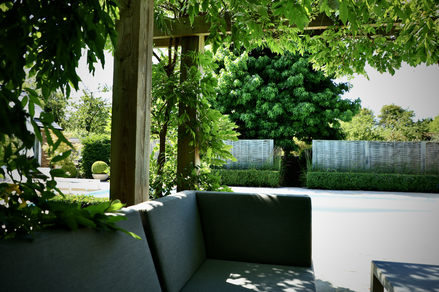 garden sofa under pergola on summers day at oxford property