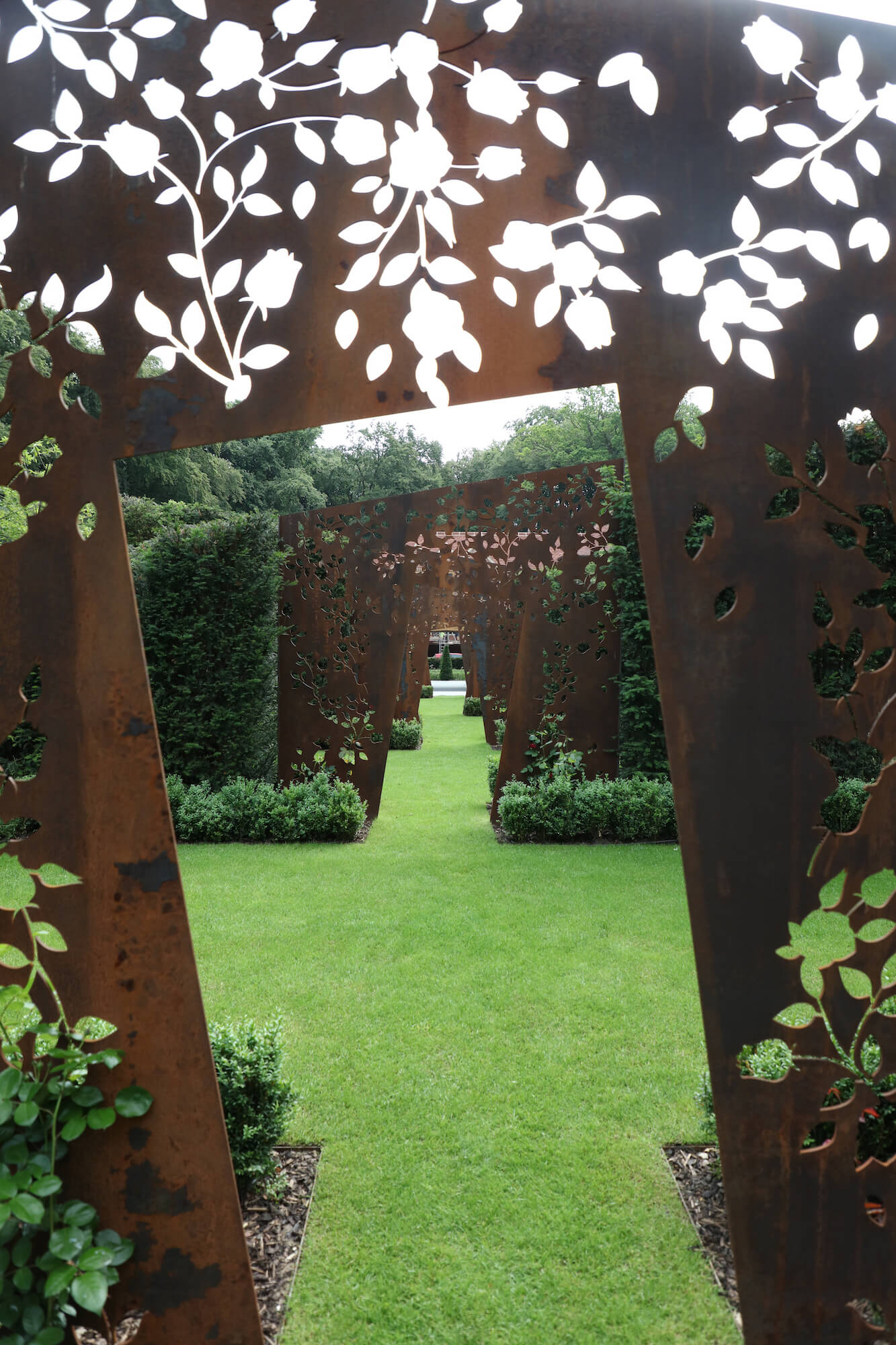 corten laser cut garden doorway sculptures in a rose garden in Oxfordshire