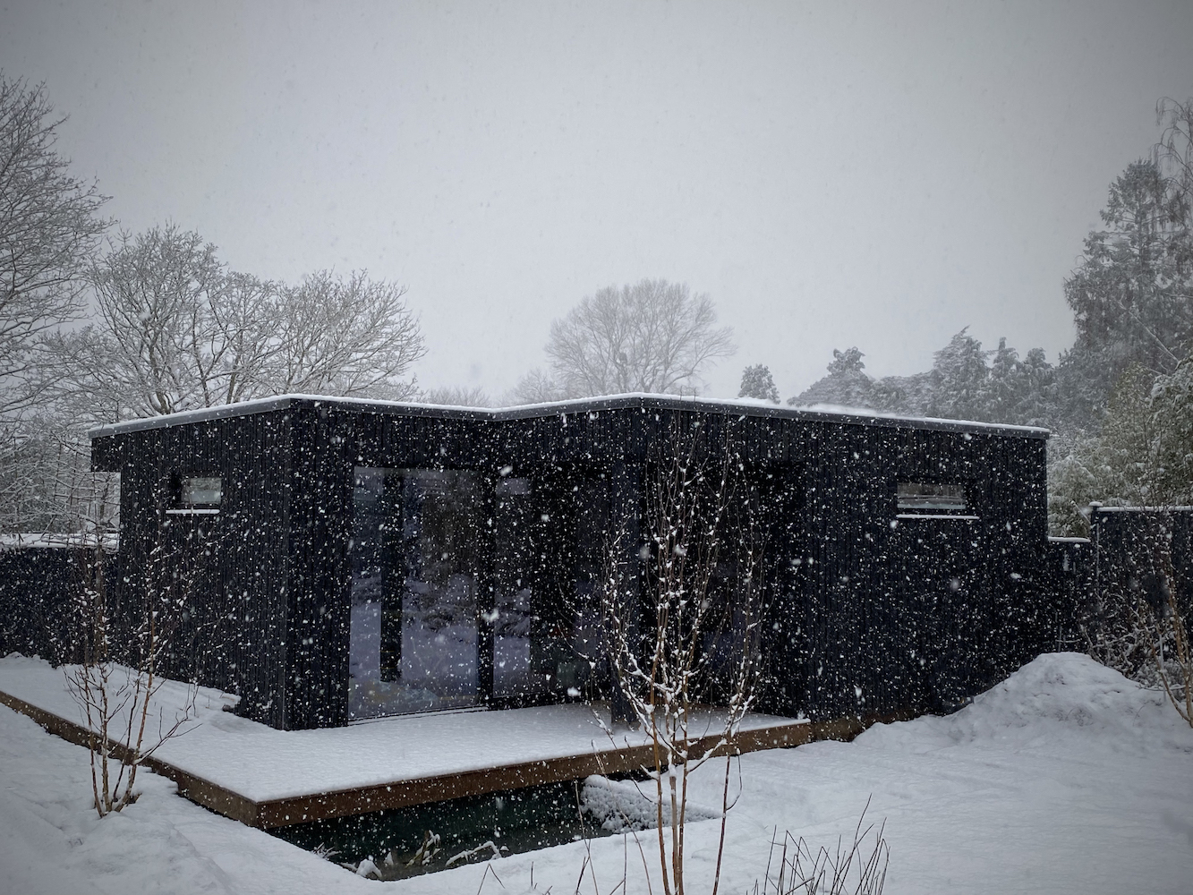 snow falling on home garden office