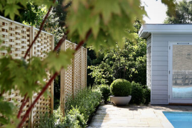 Swimming pool with topiary and pool changing room