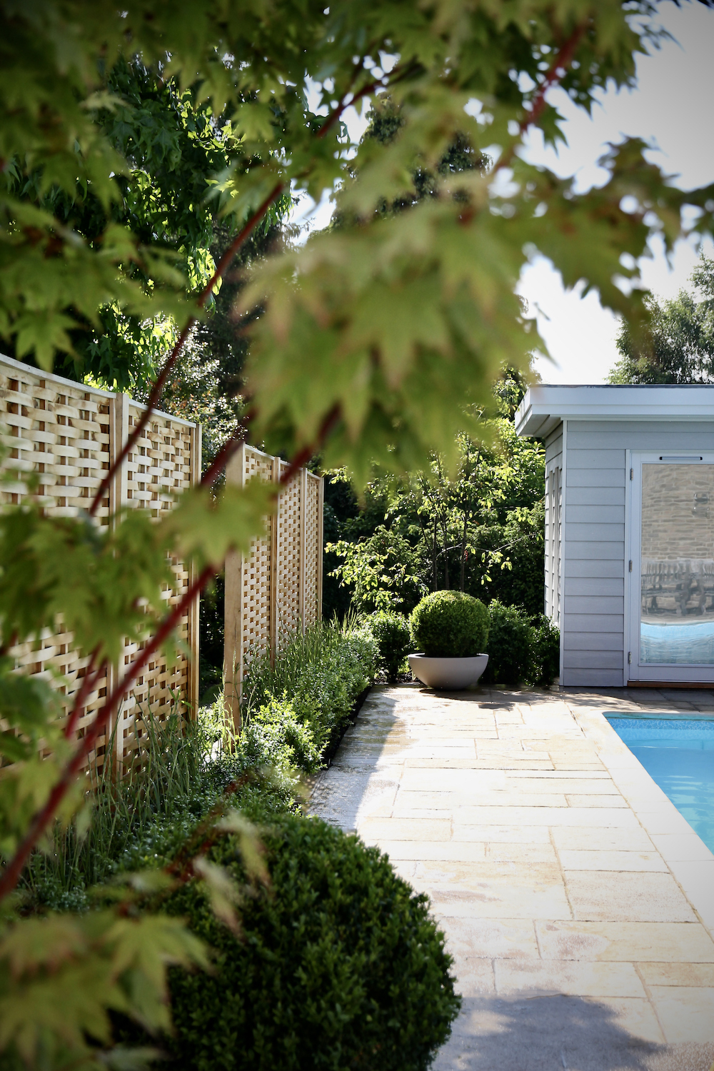 Swimming pool with topiary and pool changing room