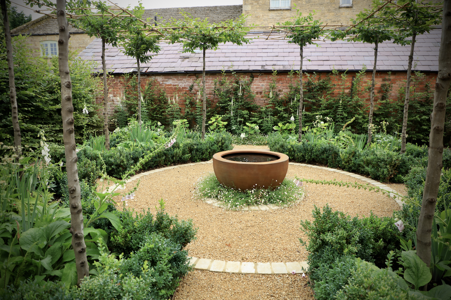 View of water feature in the centre of a parterre garden in circular shape