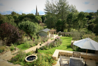 View of the garden from above, of garden furniture, higgin pathways, water feature