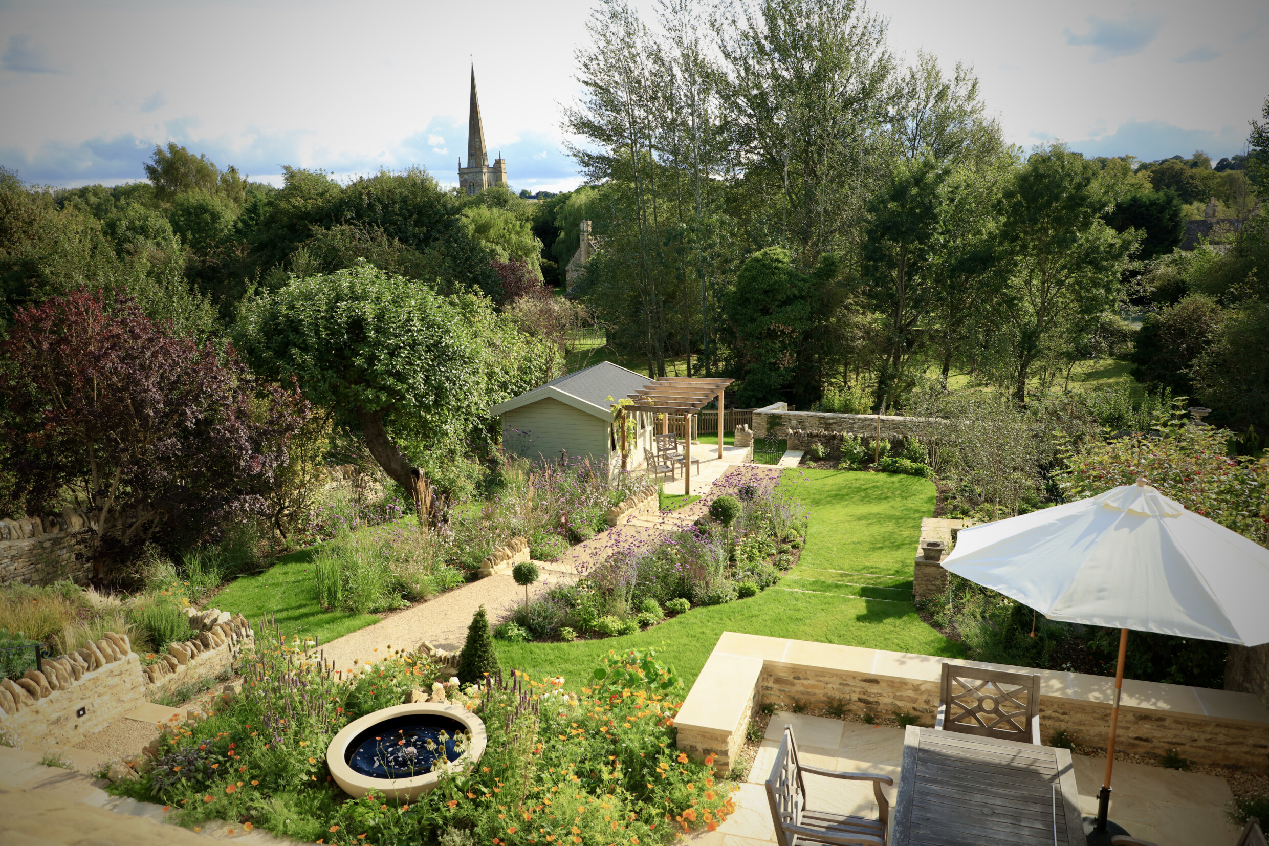 View of the garden from above, of garden furniture, higgin pathways, water feature