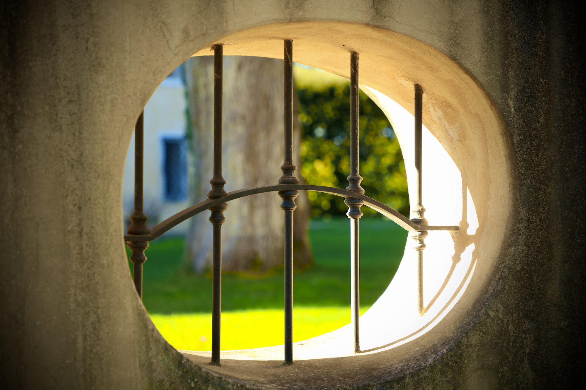 Tuscan villa with stone wall window and metal bars