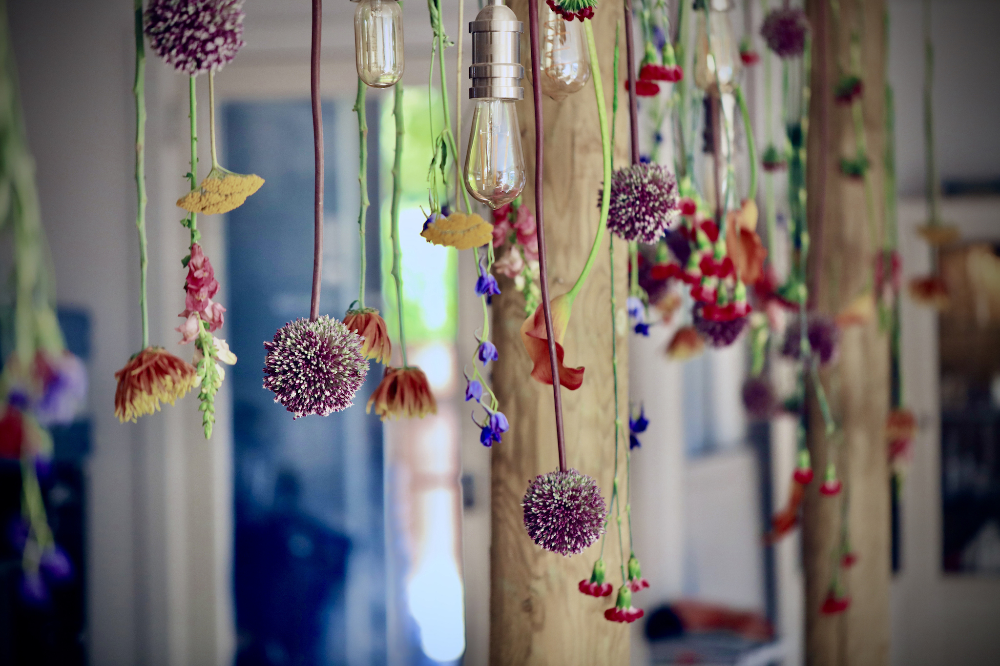 Hanging floral installation in design barn in cotswolds