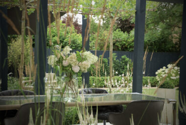 Freshly cut hydrangeas on indian ocean table beneath arbors