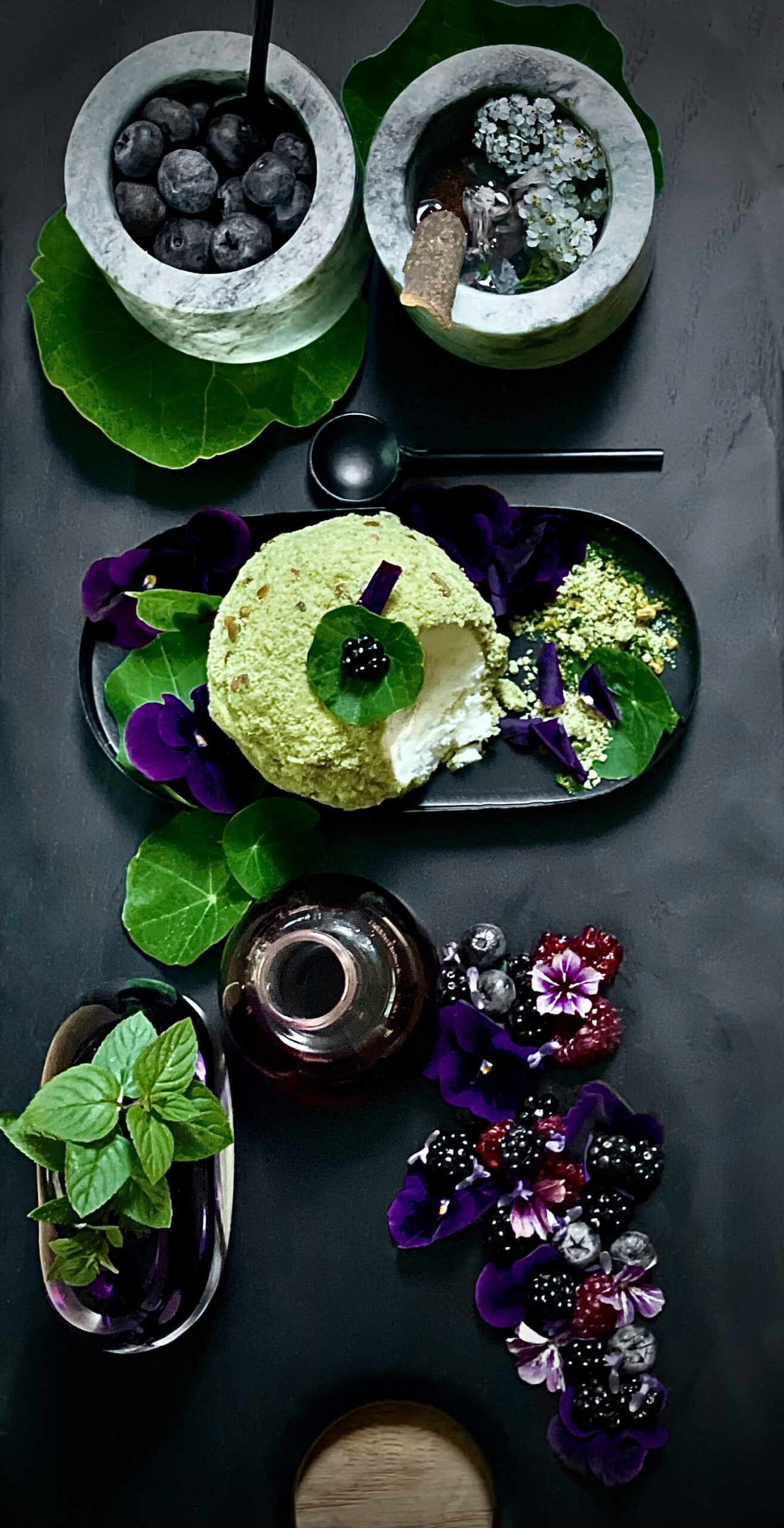 Pistachio icecream bomb with fresh fruit and viola 