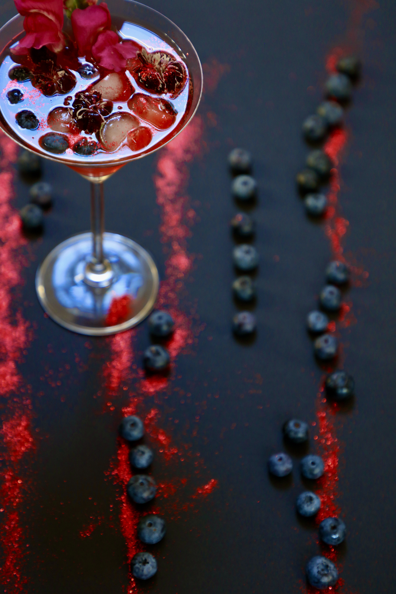 Snapdragon daiquiri with red glitter and blueberries 