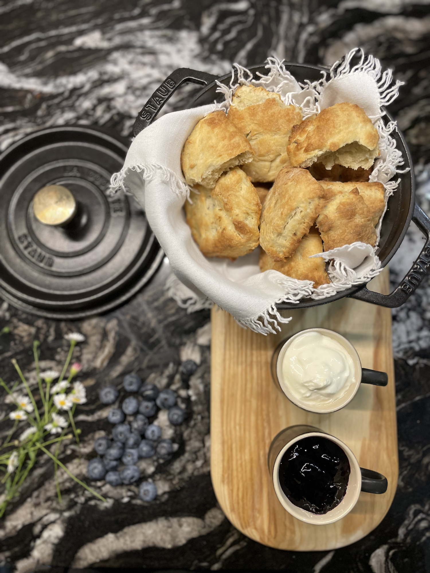 Fireweed scones in black le cresuet style dish with clotted cream and jam 