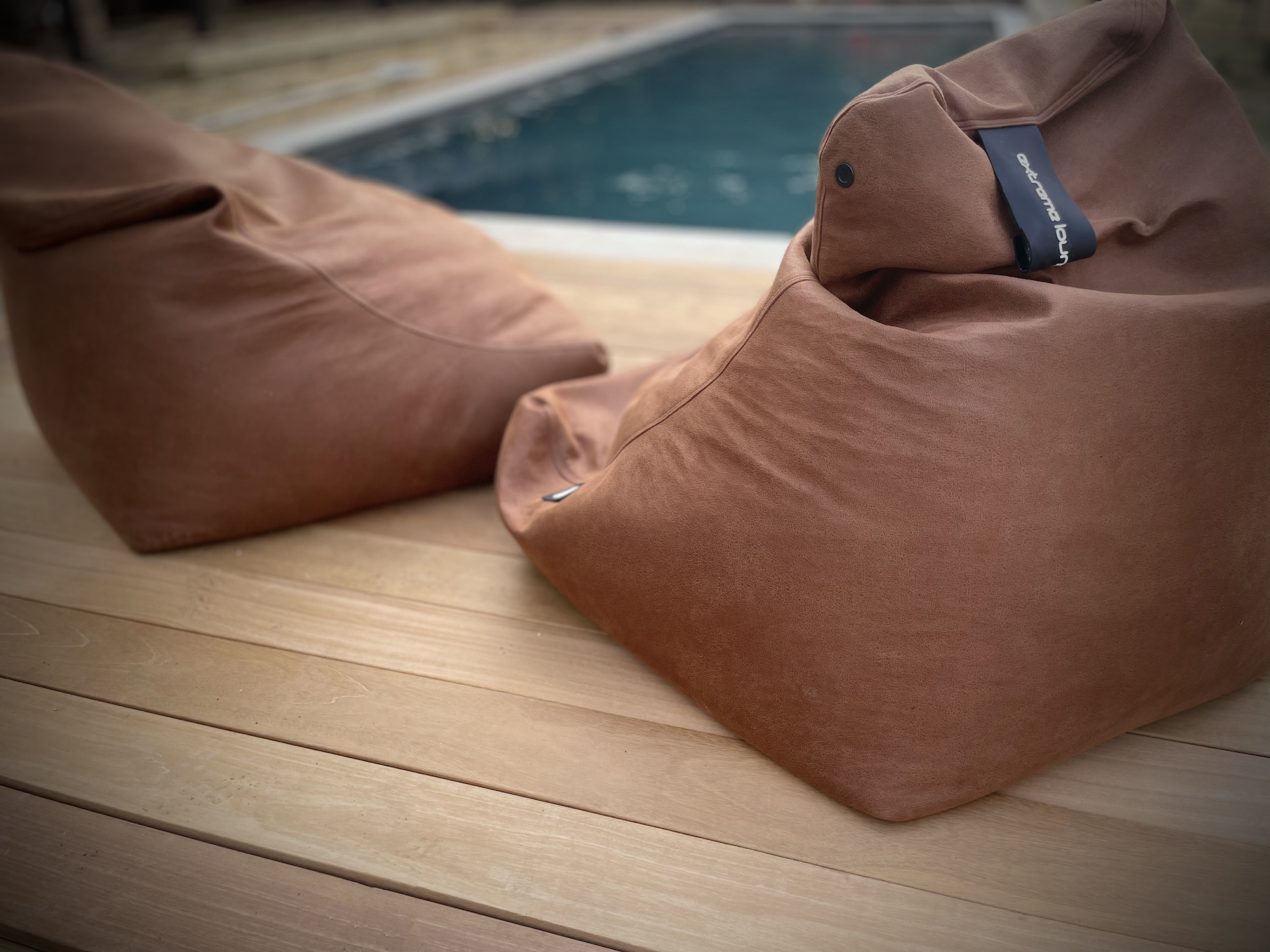 Leather bean bags beside oxfordshire pool