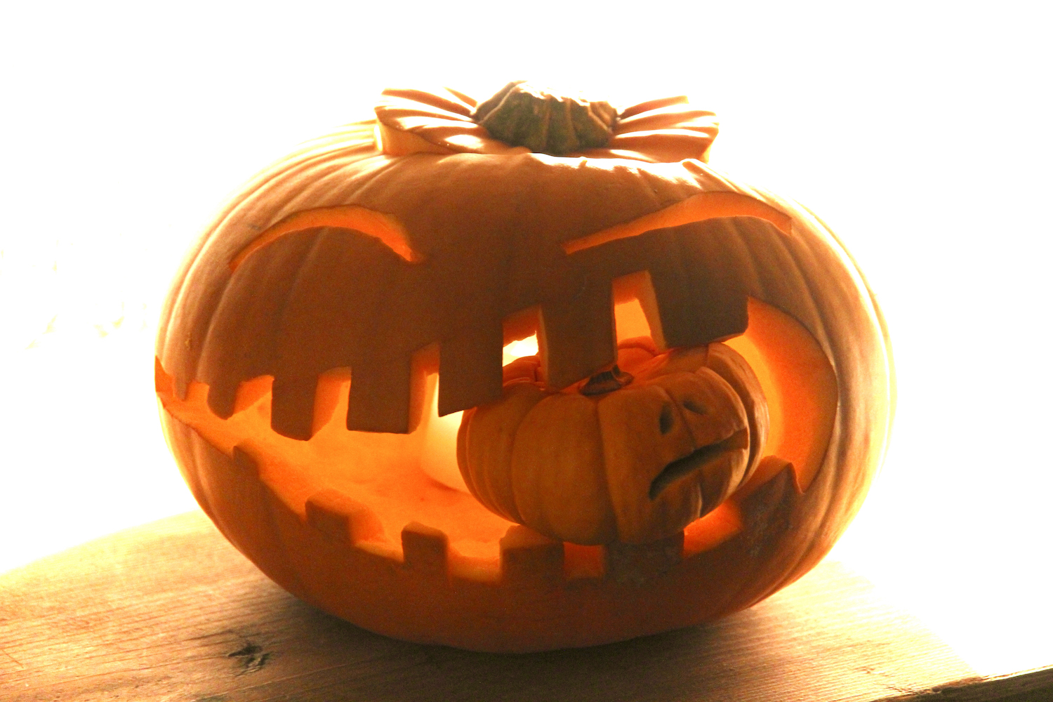 amazing pumpkin carved with a baby pumpkin in mouth