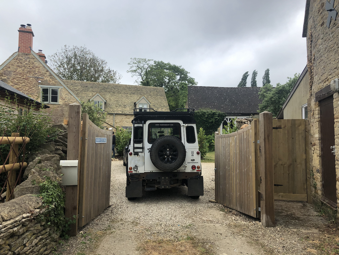 Hendy Cursor White defender driving into Barn Cottage, Kingham gates