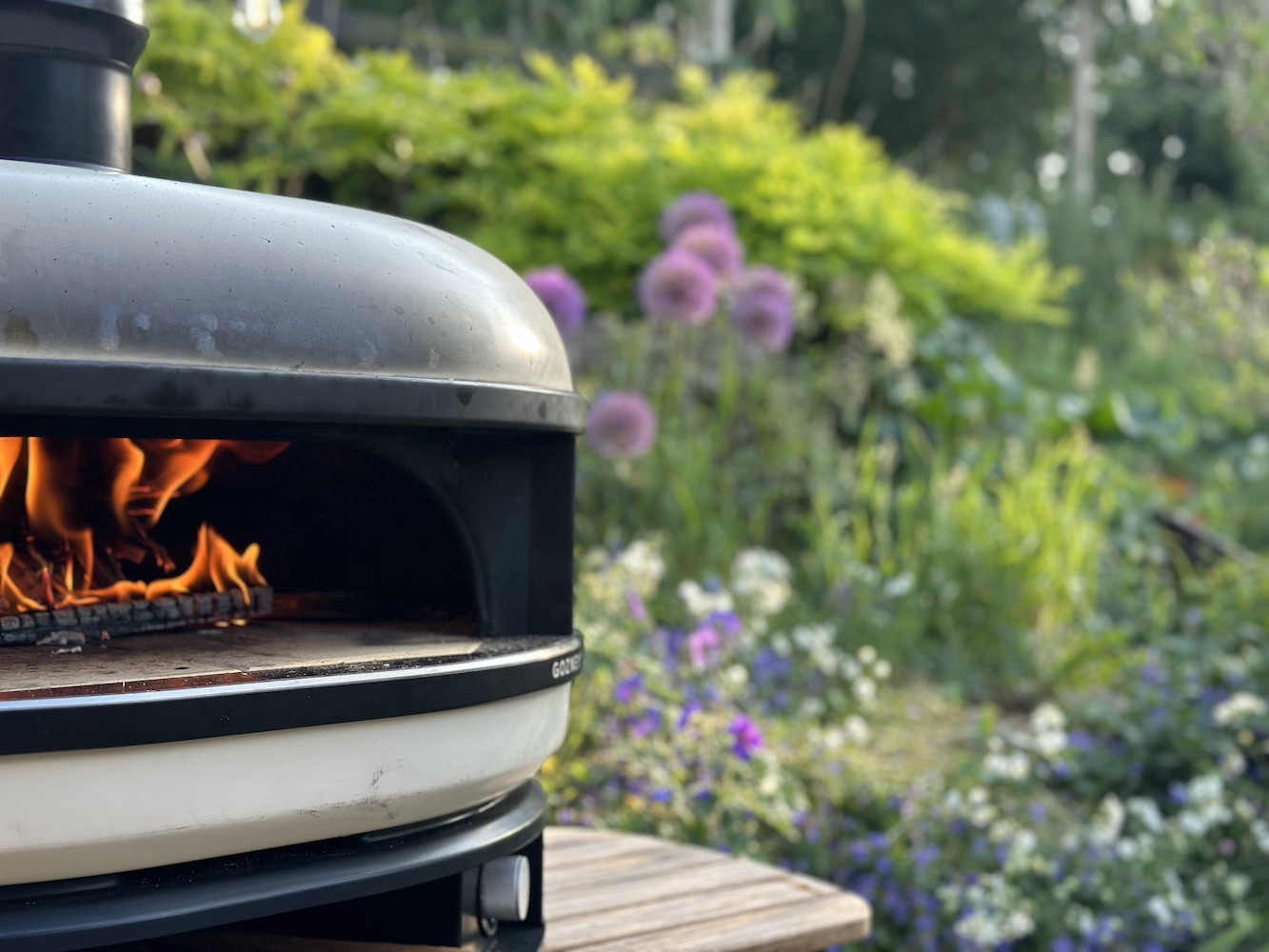 Gozney wood fired Pizza oven at the rolling hound in the cotswold. Ridge bank planting in the background