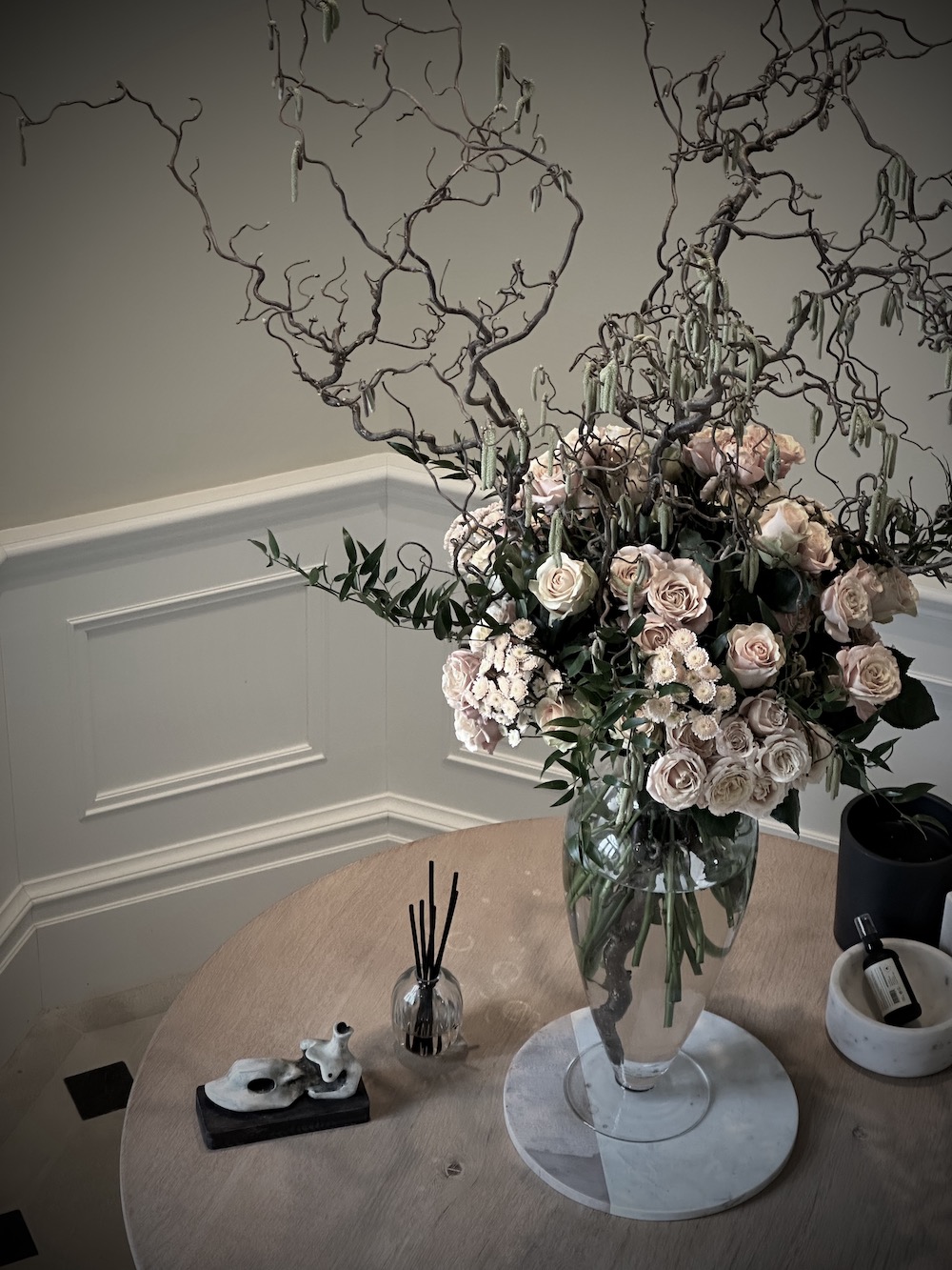 Welcome home floral installation in blush tones with contorted hazel with catkins