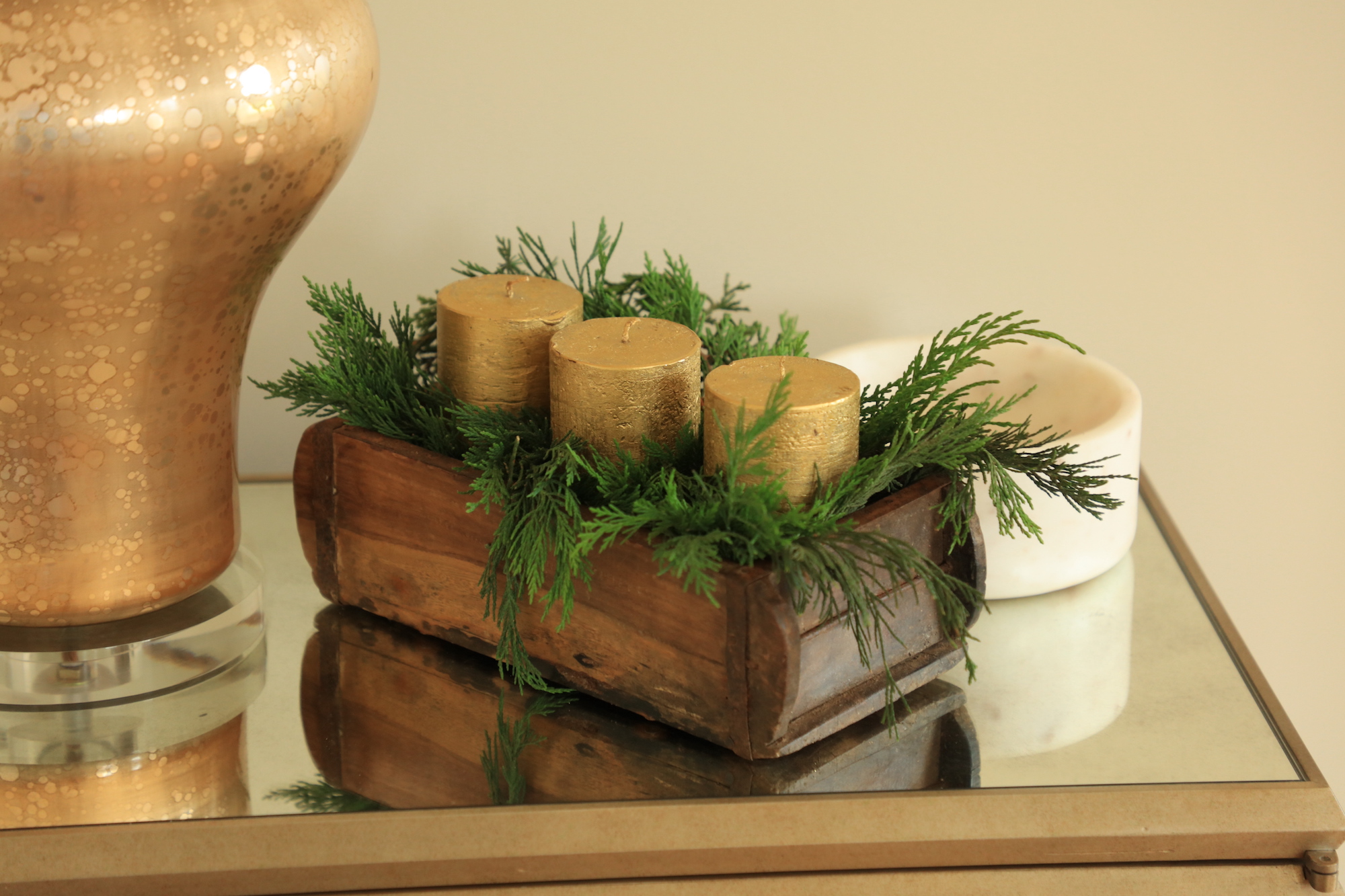 Gold church pillar candles in traditional brick mould and conifer sprigs