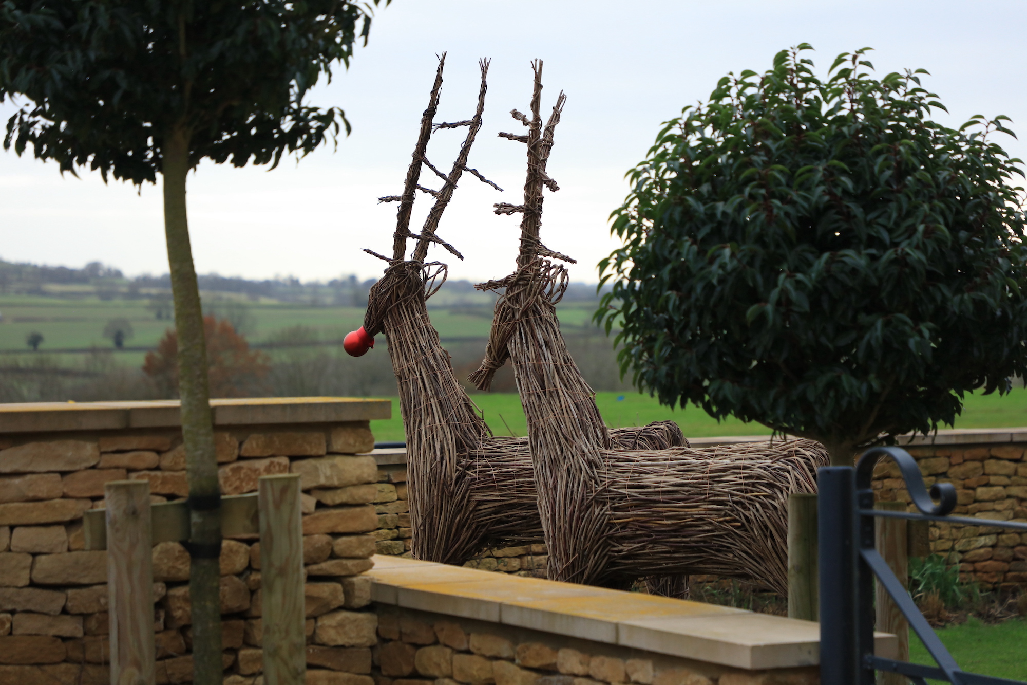 Wicker reindeer on brow of hill at Sibford Park by hendy curzon gardens