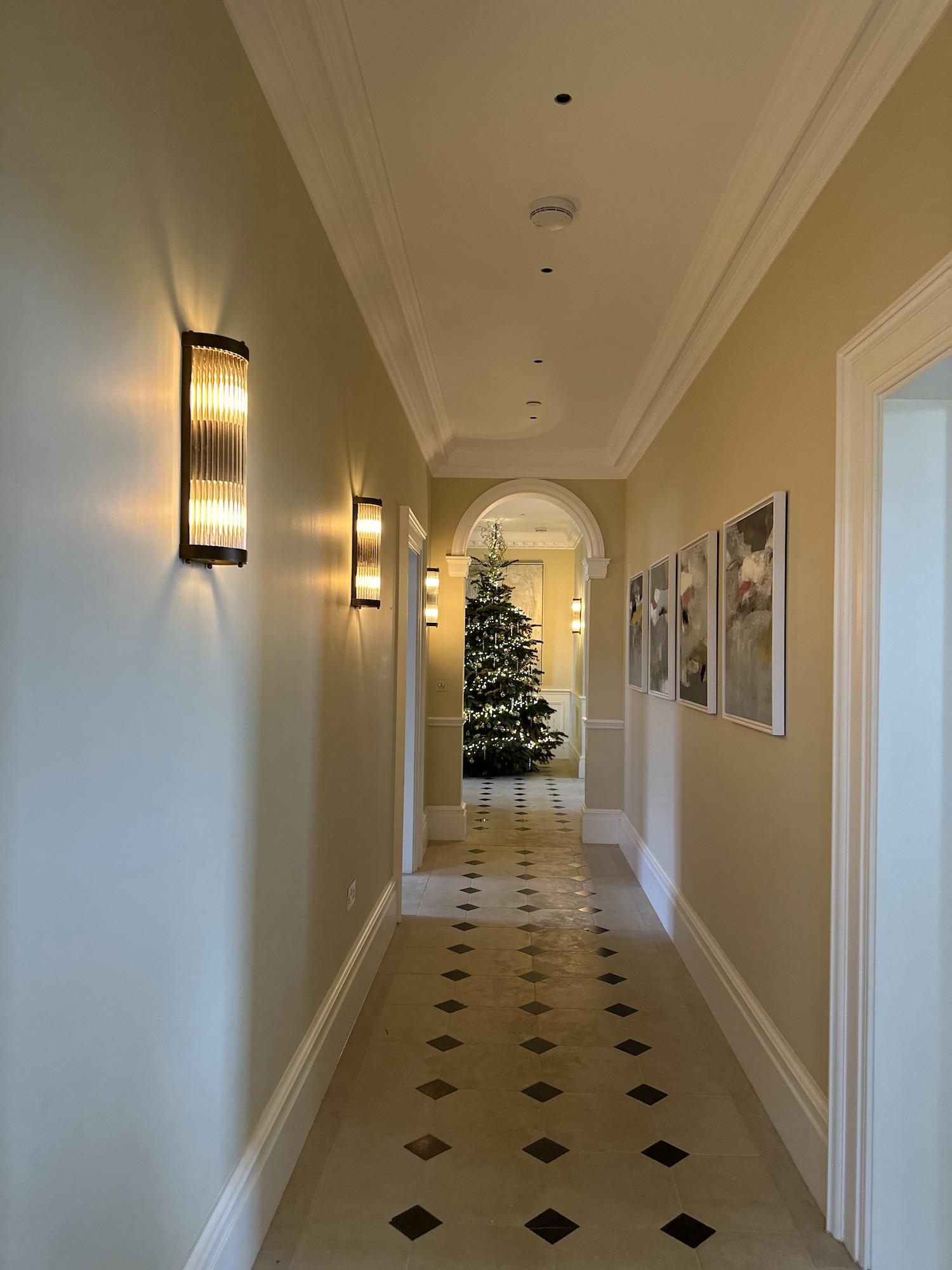 corridor leading to huge christmas tree decorated in gold champagne