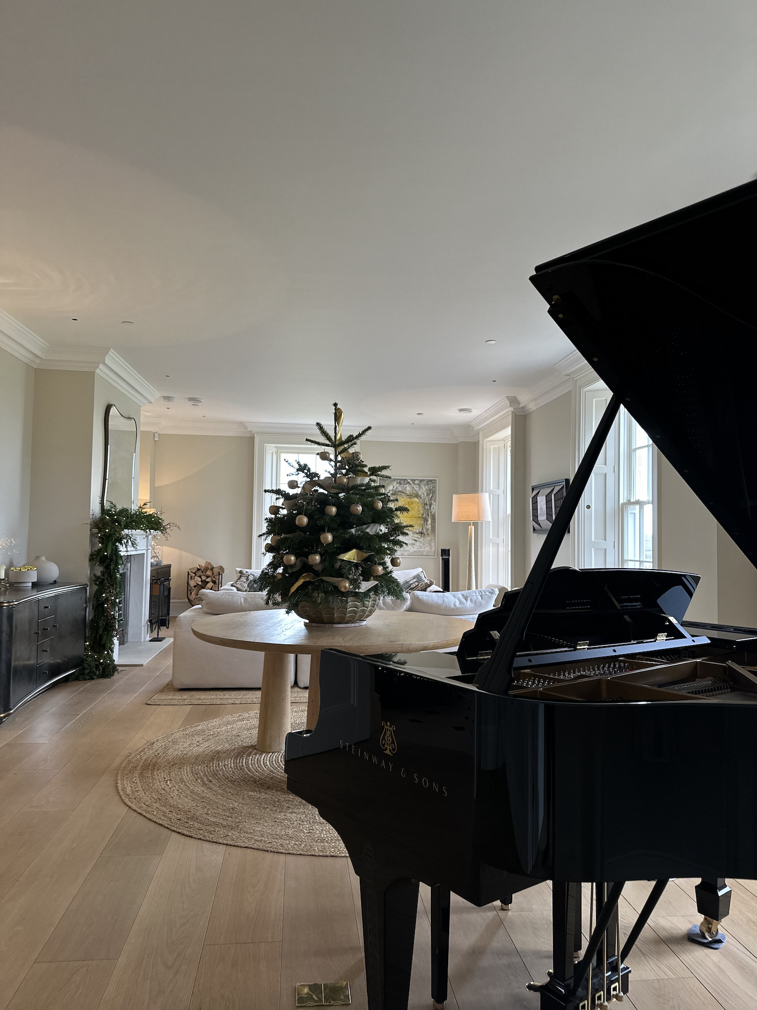 Mini Christmas tree with golden apples in Oxfordshire living room by hendy curzon gardens